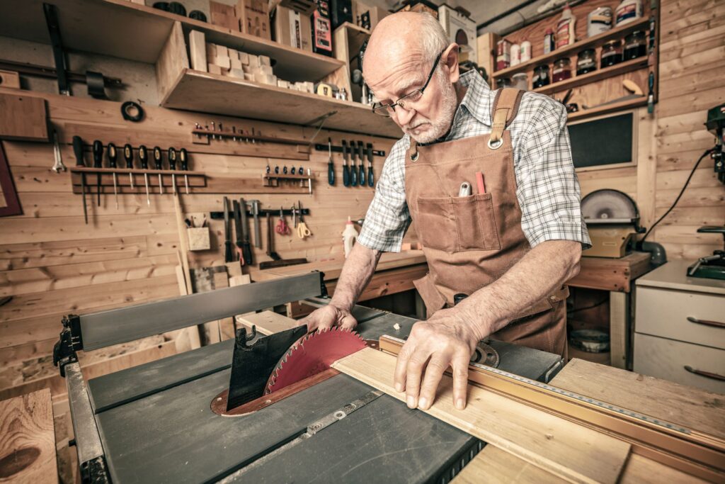 Retired man working on a woodworking project in his home workshop