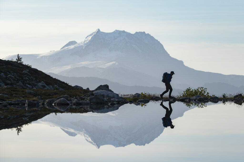 Man sitting alone at sunrise, thinking through a retirement built with little or no savings