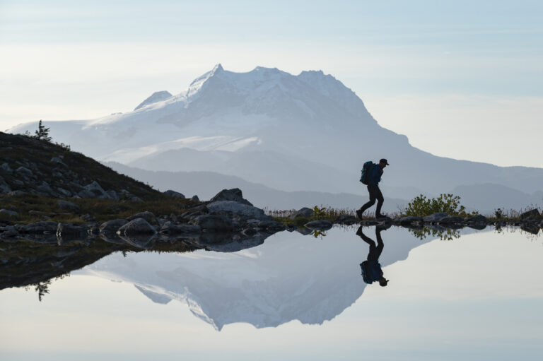Man sitting alone at sunrise, thinking through a retirement built with little or no savings